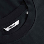 Black t-shirt with a brand label on the collar