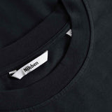 Black t-shirt with a brand label on the collar