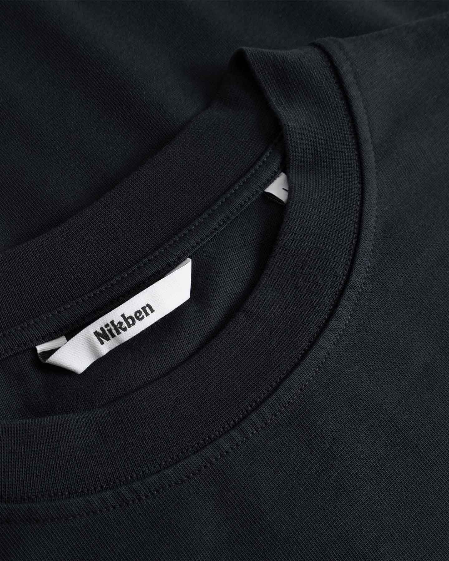 Black t-shirt with a brand label on the collar
