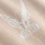 Close-up of a logo on a beige fabric 