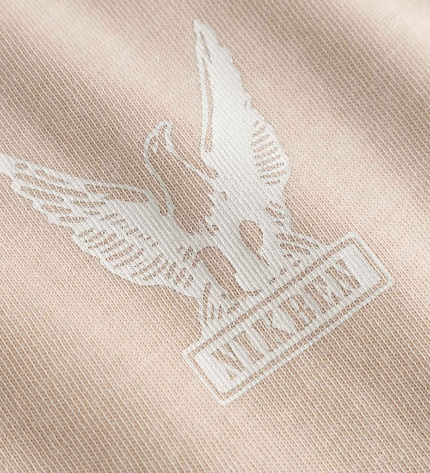Close-up of a logo on a beige fabric 
