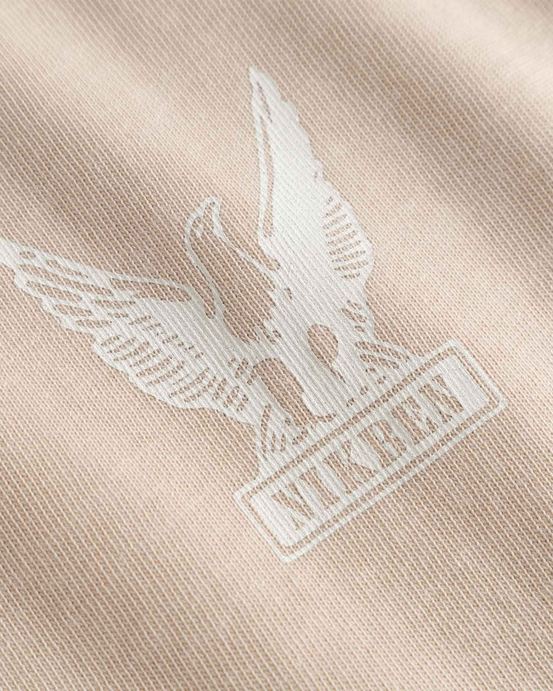 Close-up of a logo on a beige fabric