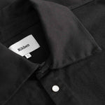 Close-up of black overshirt with Nikken label inside the collar