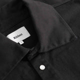 Close-up of black overshirt with Nikken label inside the collar