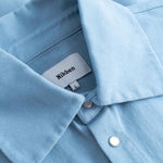 Close-up of a light blue long sleeved shirt with visible Nikben label inside the collar.