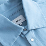 Close-up of a light blue long sleeved shirt with visible Nikben label inside the collar.