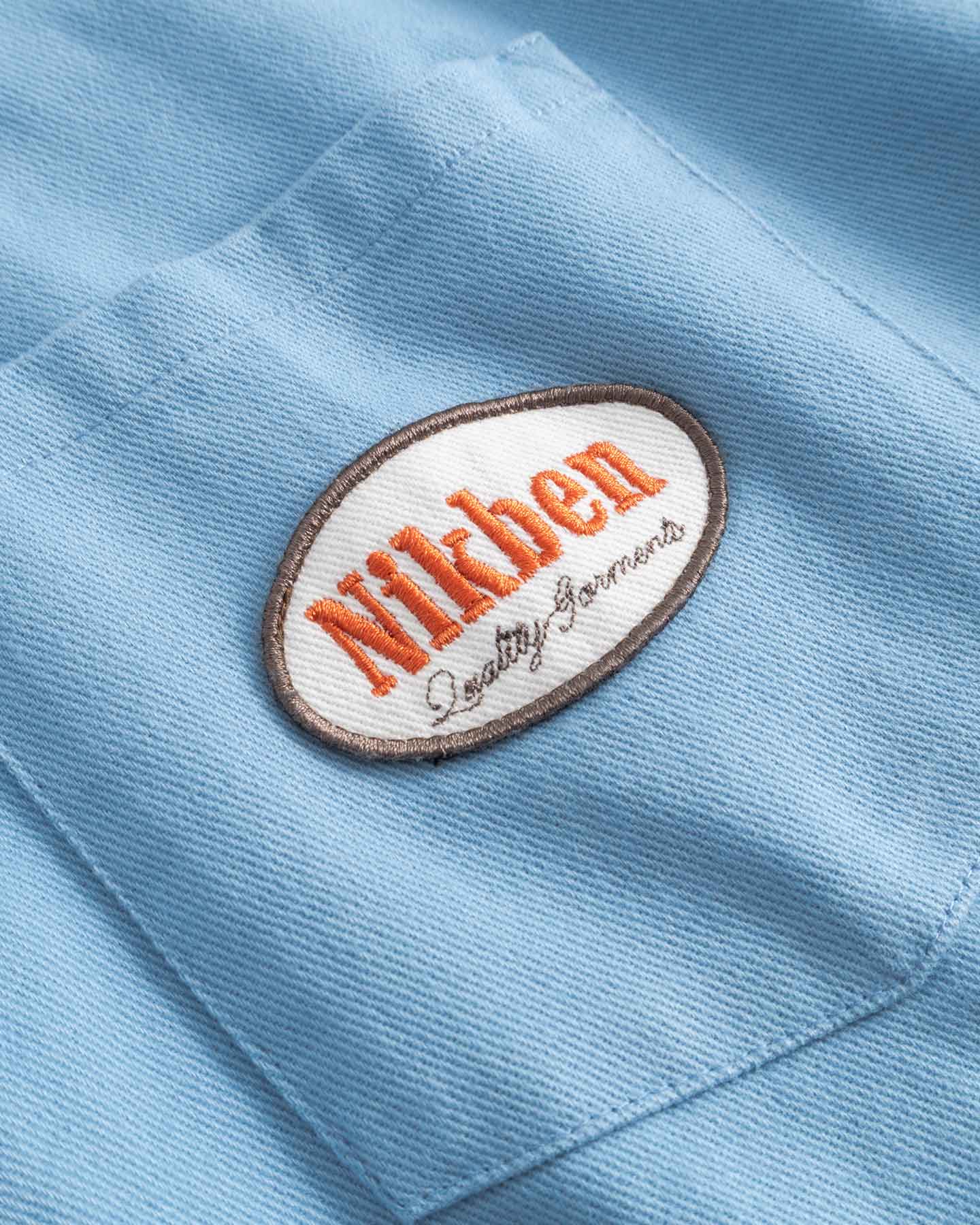 Close up of Nikben brand logo on breast pocket