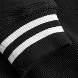 Close-up of sleeve with white stripes on black bomber jacket