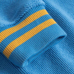 Close-up of blue fabric with yellow stripes on sleeve