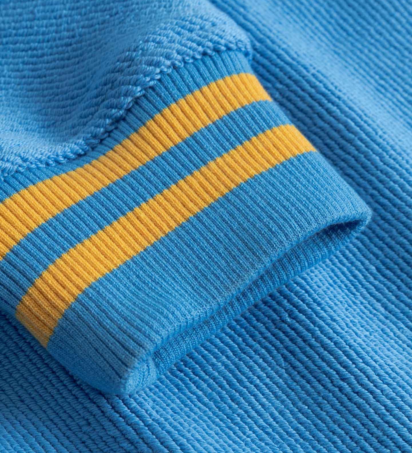 Close-up of blue fabric with yellow stripes on sleeve