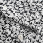 Close-up of textured black and white fabric on cardigan