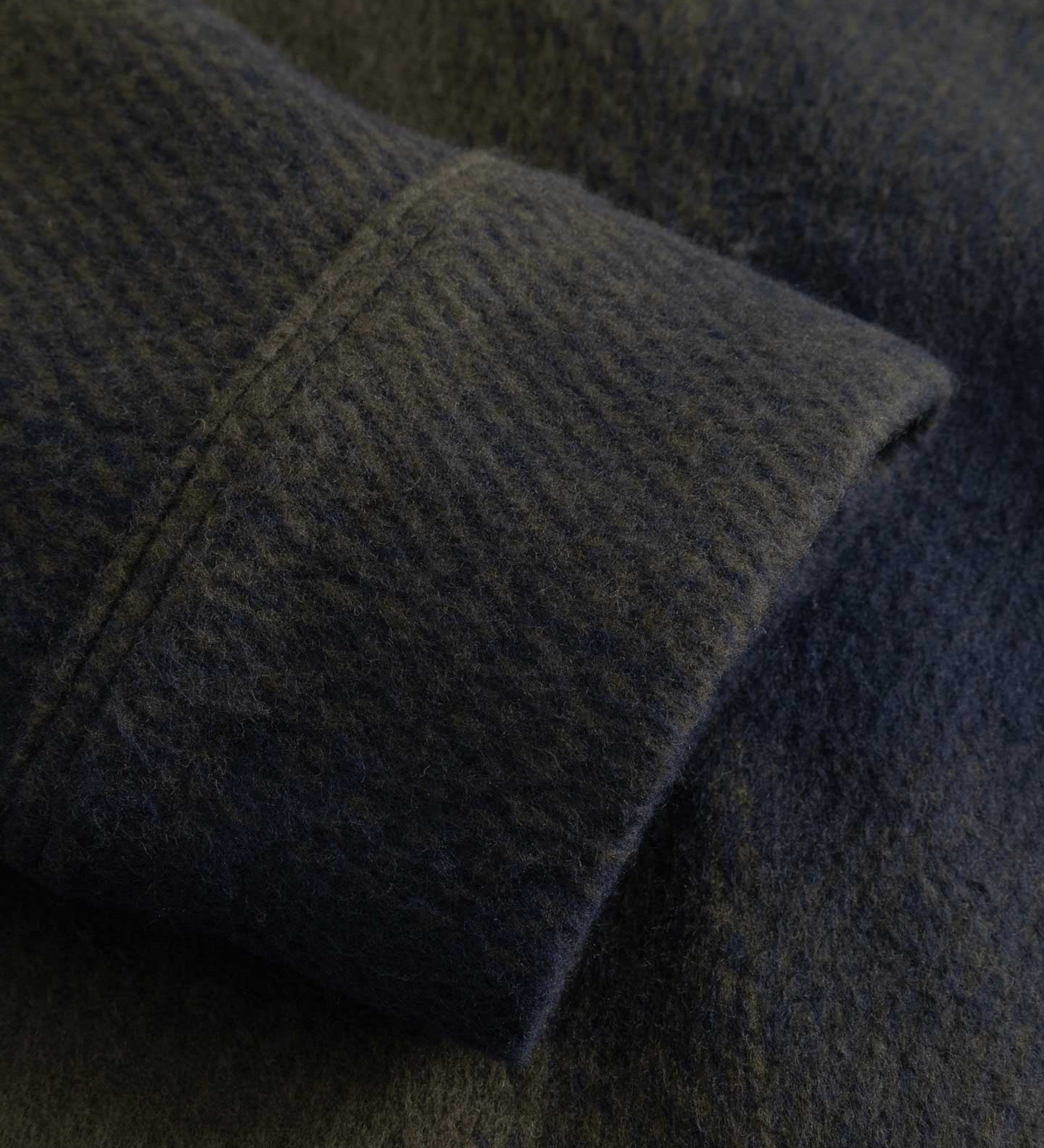 Close-up of a textured fabric with a focus on the texture and color gradient.