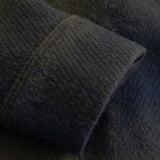 Close-up of a textured fabric with a focus on the texture and color gradient.