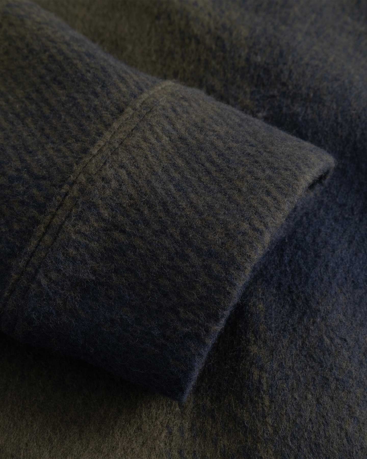 Close-up of a textured fabric with a focus on the texture and color gradient.