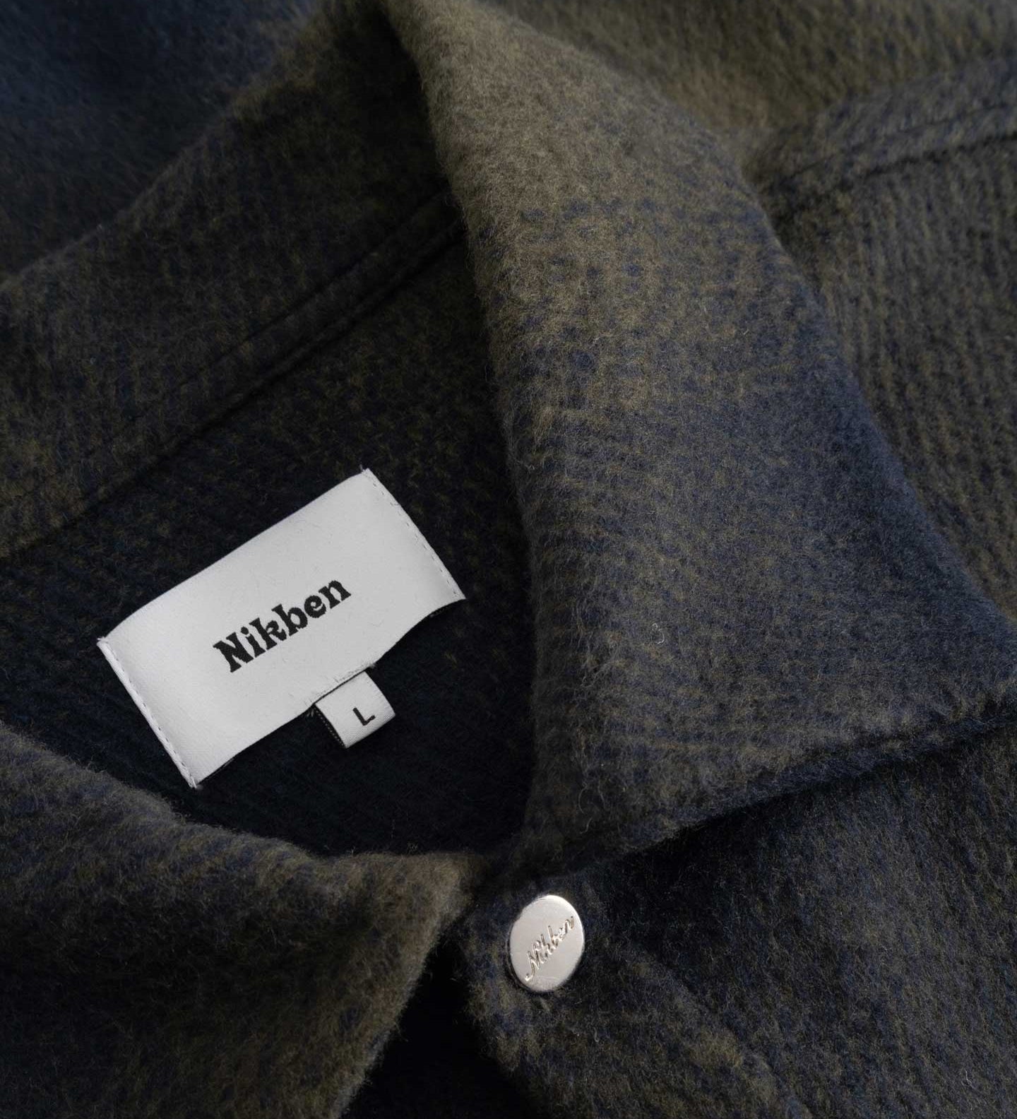 Close up of dark blue and green Flannel overshirt fabric details