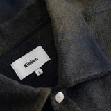 Close up of dark blue and green Flannel overshirt fabric details