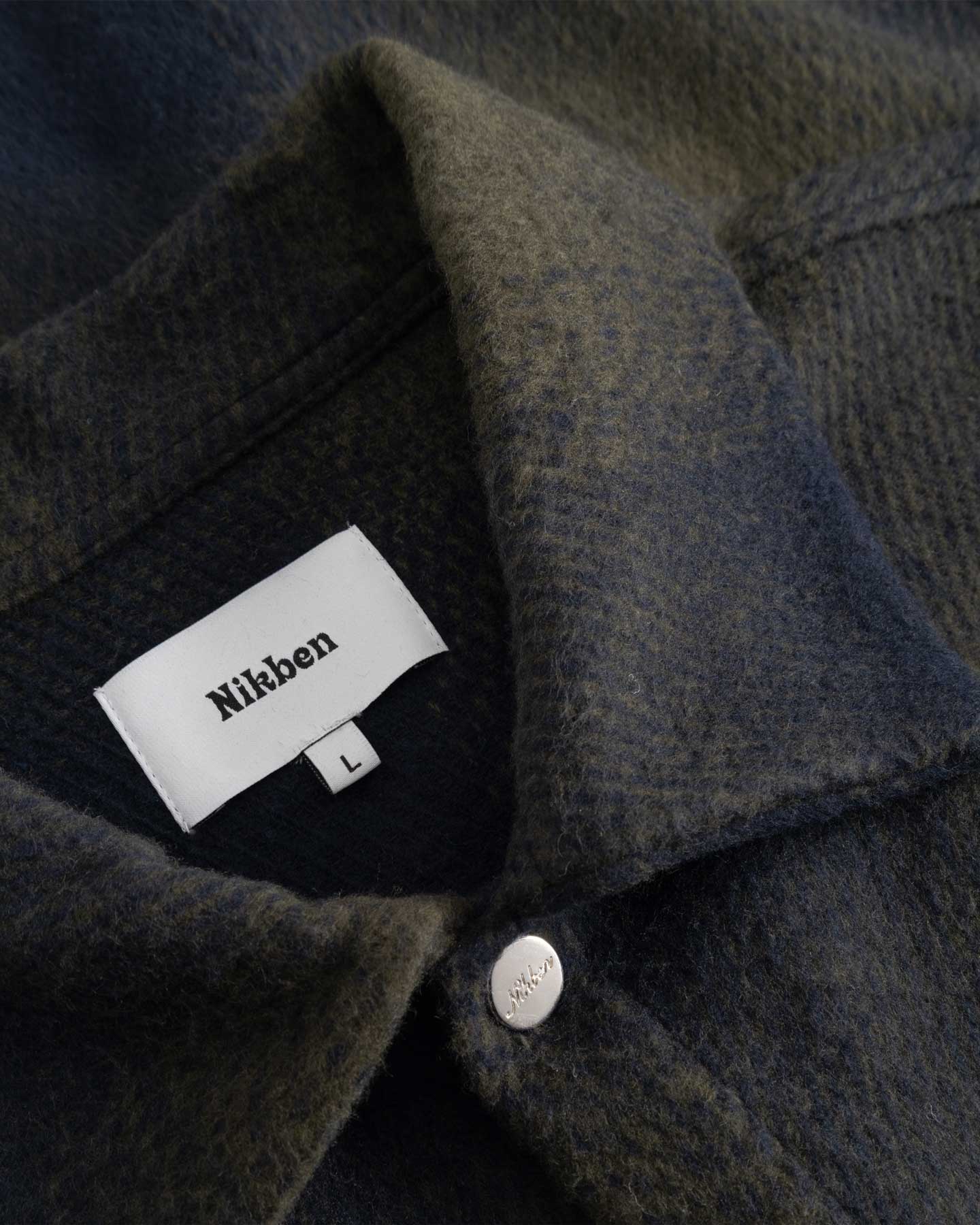 Close up of dark blue and green Flannel overshirt fabric details
