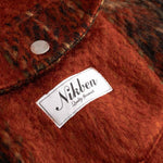 Close-up of front breast button down pockets fabric with a Nikben label