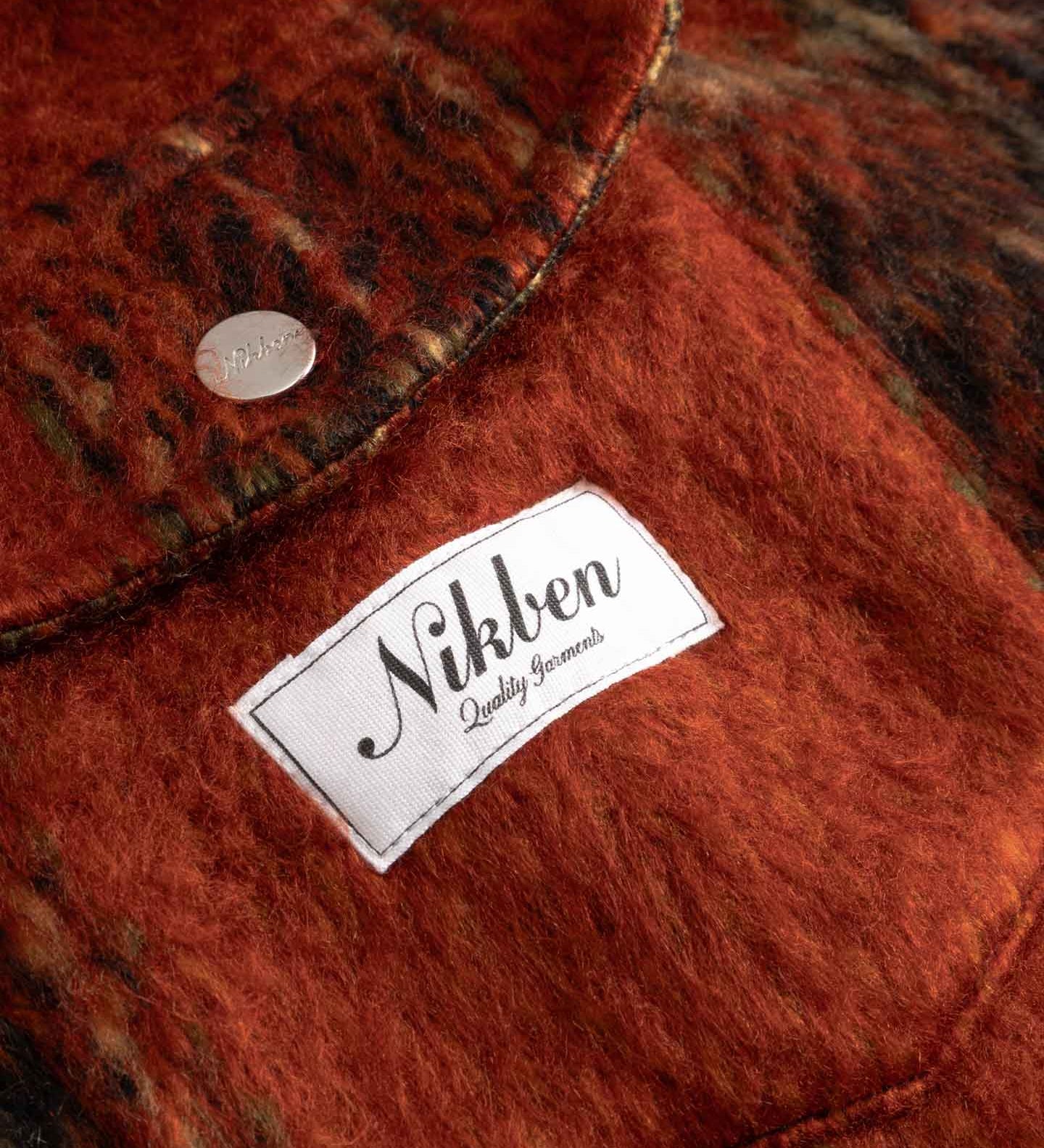 Close-up of front breast button down pockets fabric with a Nikben label