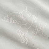 Close-up of design of a winged creature.