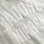 Close up of Embroidered text on a beige fabric background