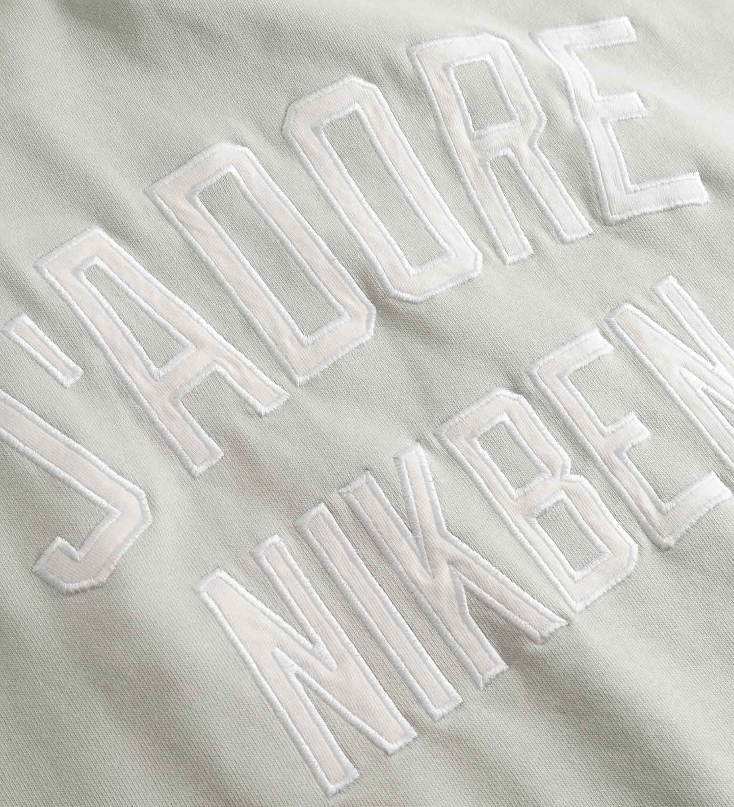 Close up of Embroidered text on a beige fabric background