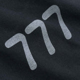 Close-up of a black fabric with white 777 logo