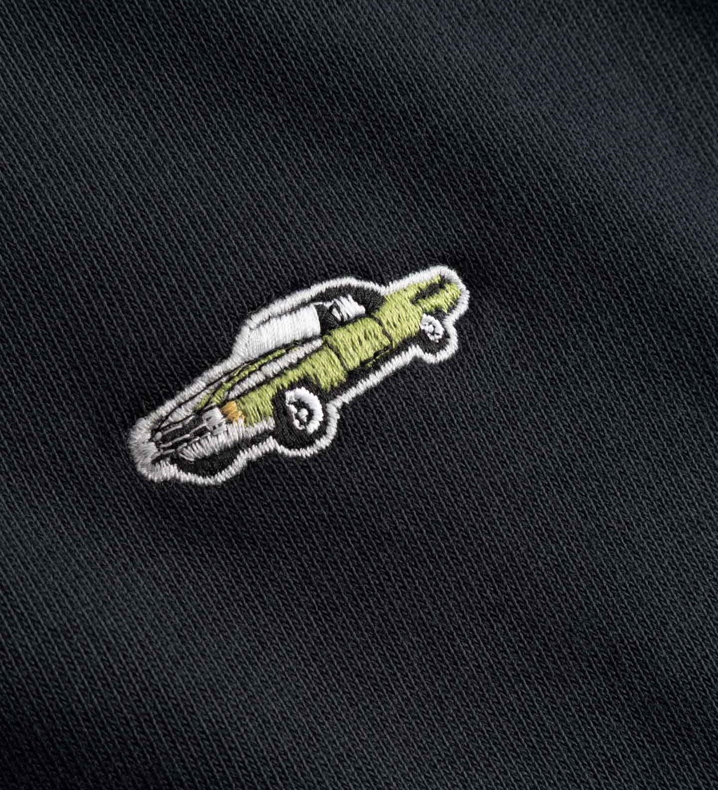 Embroidered design of a car on a black fabric