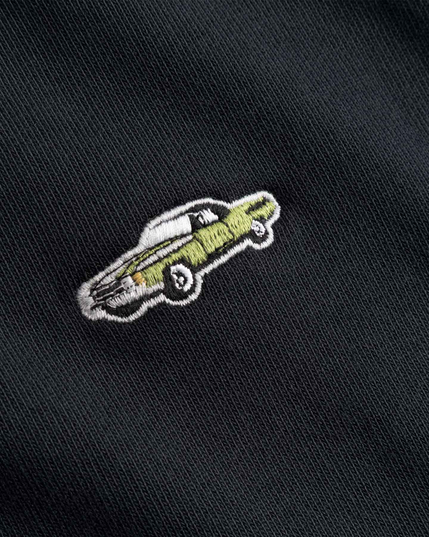 Embroidered design of a car on a black fabric