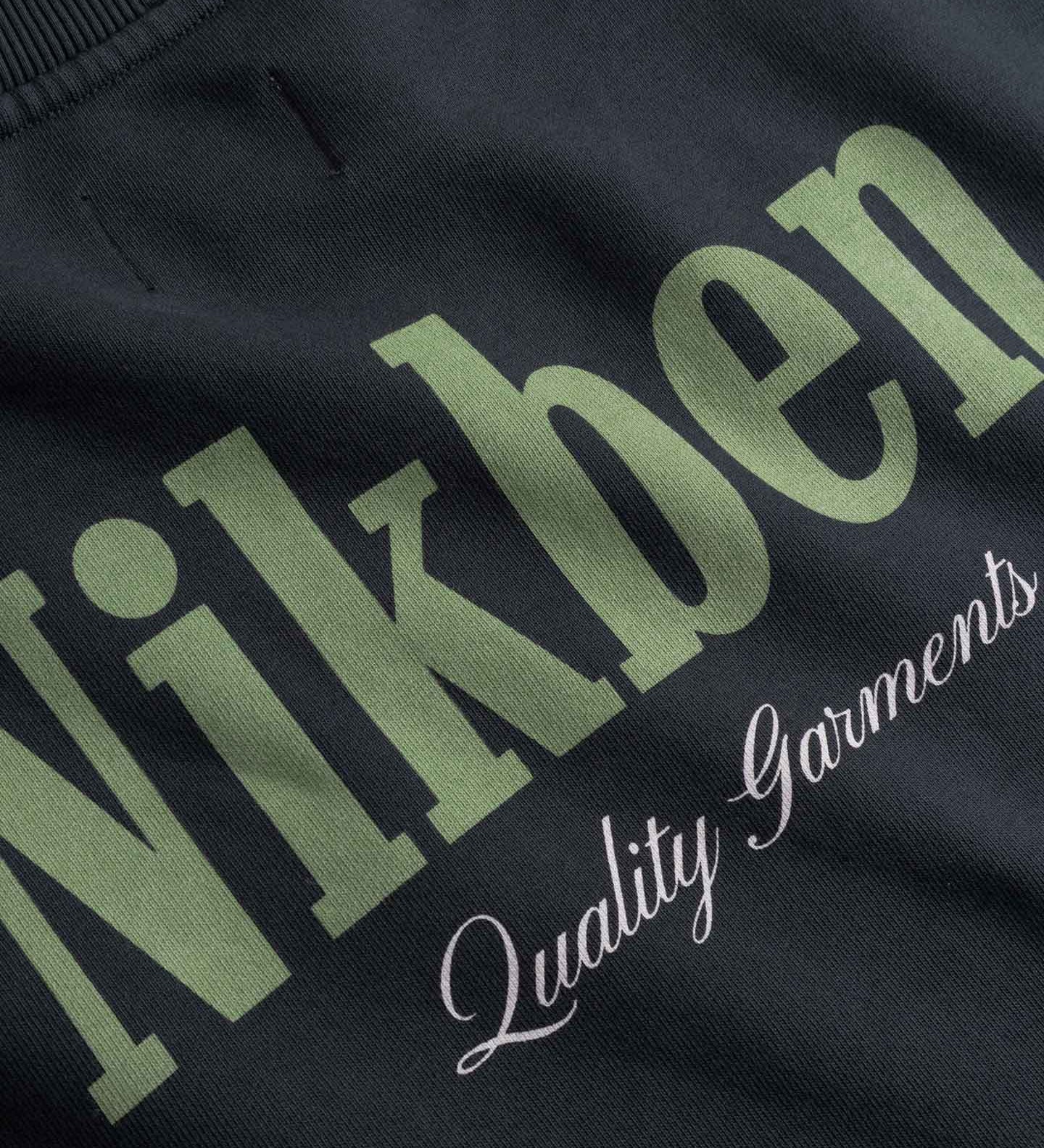 Close up of Text 'Nikben Quality Garments' on a back
