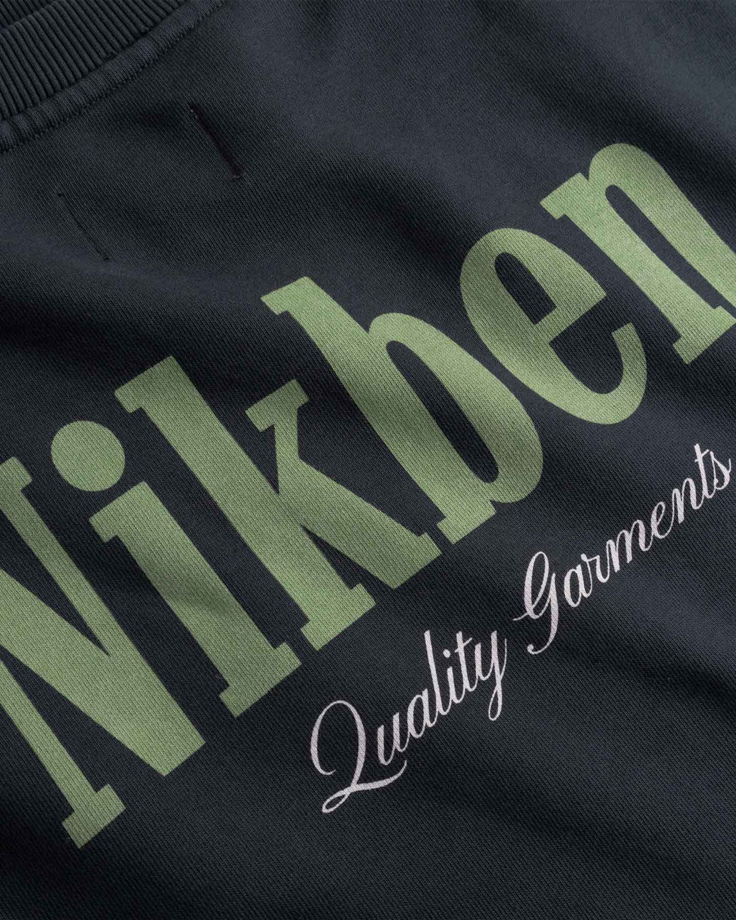Close up of Text 'Nikben Quality Garments' on a back