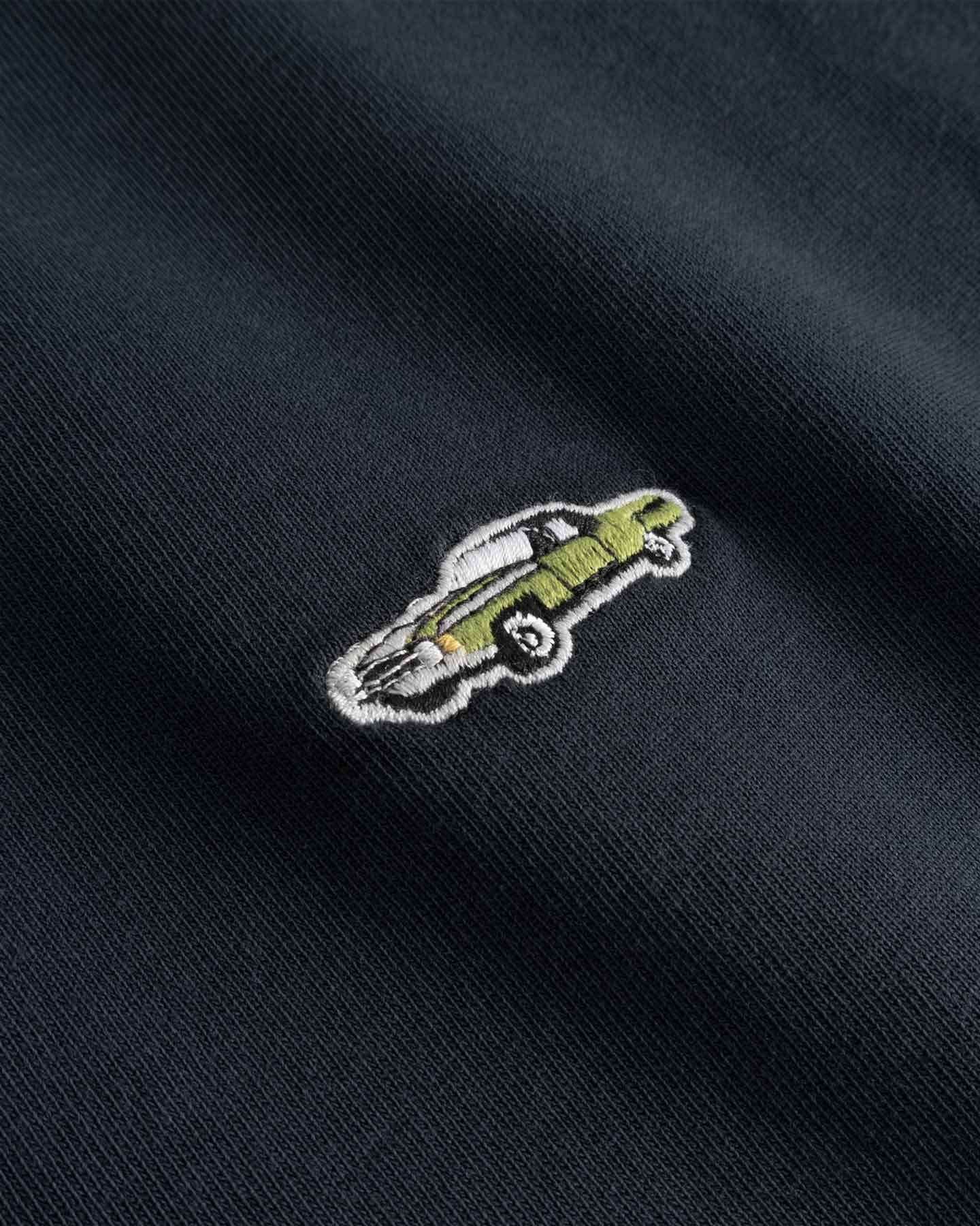 Close up of Embroidered car design on a black fabric 