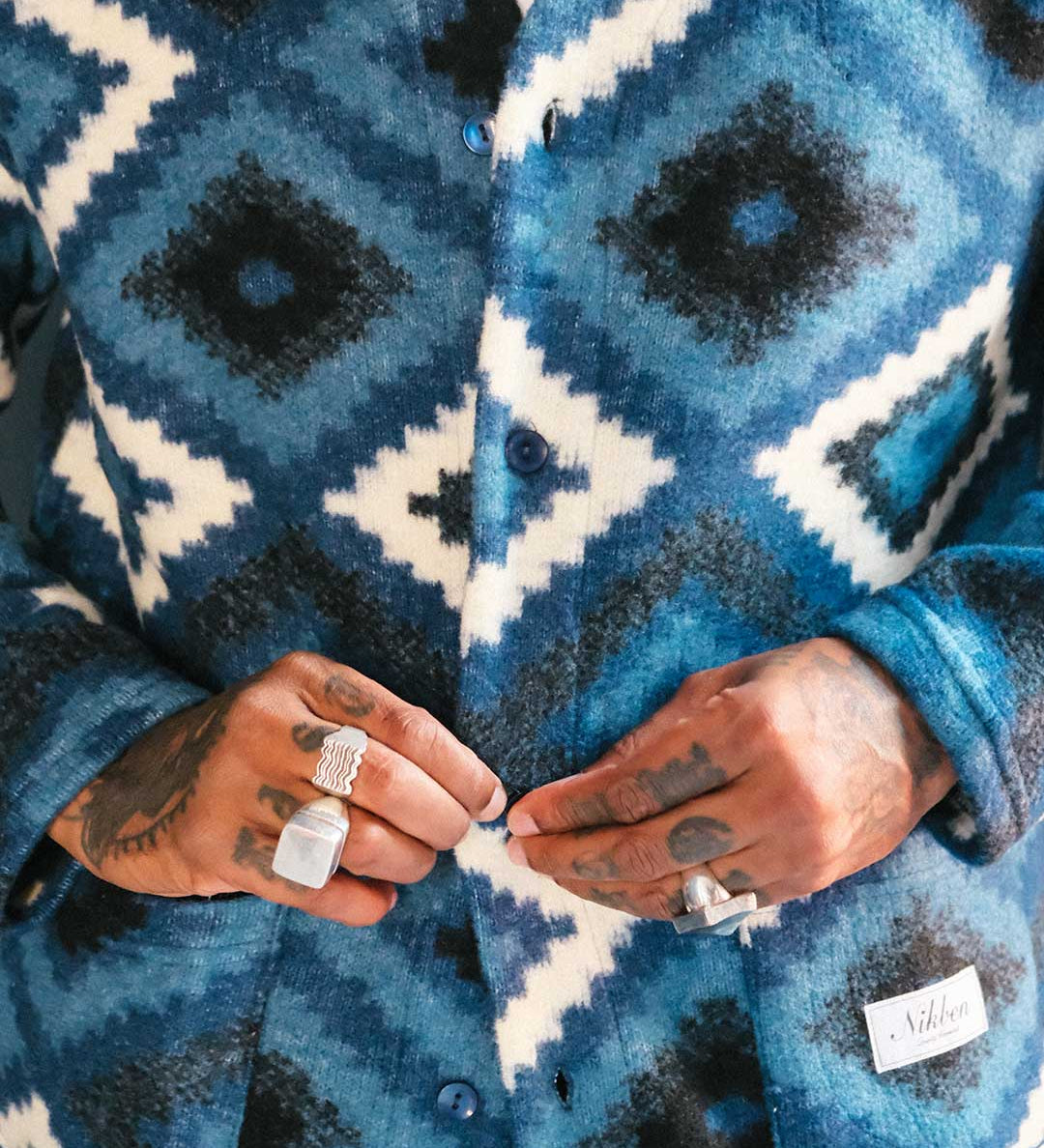 Close up of blue and white Ikat Diamond patterned cardigan 