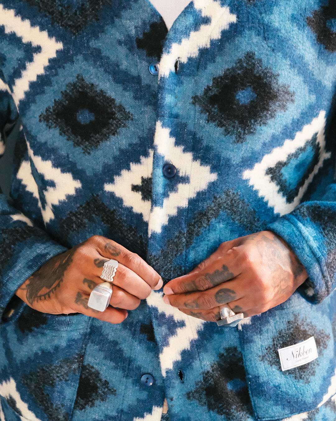 Close up of blue and white Ikat Diamond patterned cardigan 