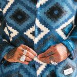 Close up of blue and white Ikat Diamond patterned cardigan 