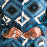 Close up of blue and white Ikat Diamond patterned cardigan 
