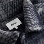 Close up of navy grey checkered pattern on overshirt Nikben label