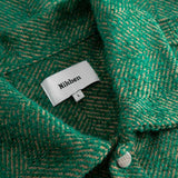 Close-up of a green textured fabric with a Nikben label.