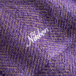 Close up of Purple fabric with 'Nikben' logo in white