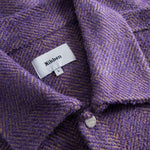 Close-up of a purple textured fabric with a Nikben label.