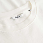 Closeup view of Nikben necklabel on white T-shirt