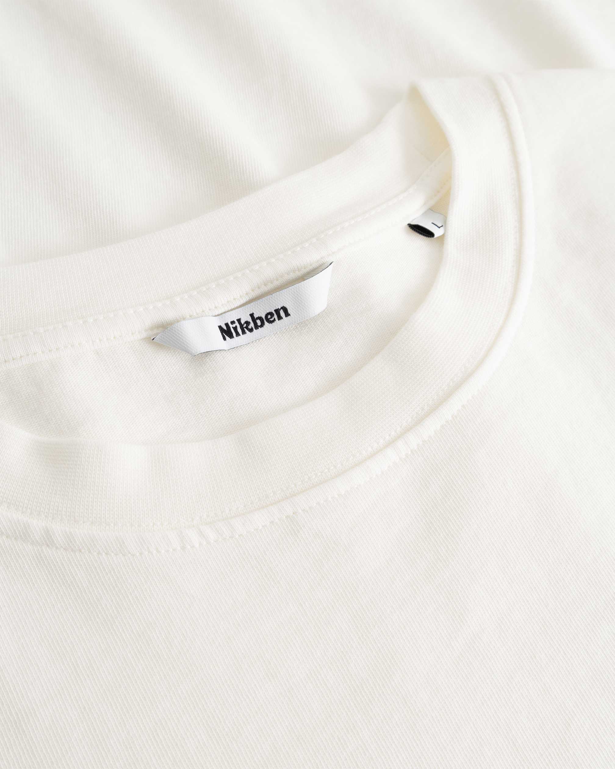 Closeup view of Nikben necklabel on white T-shirt