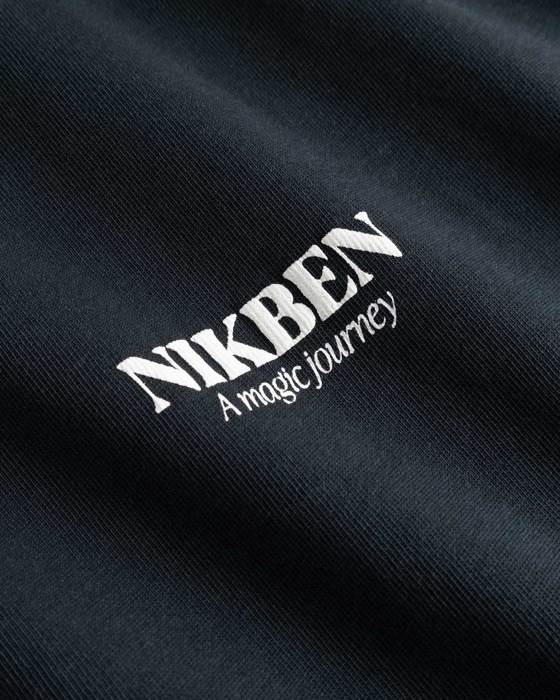 Closeup on white Nikben logo on black T-shirt