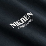Closeup on white Nikben logo on black T-shirt