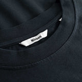 Closeup view of Nikben necklabel on black T-shirt