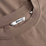 Closeup view of Nikben necklabel on brown T-shirt
