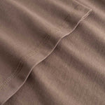 Closeup view of arm stitchings on brown T-shirt