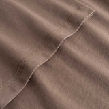 Closeup view of arm stitchings on brown T-shirt