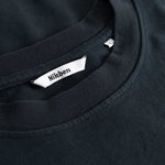 Closeup view of Nikben necklabel on black T-shirt