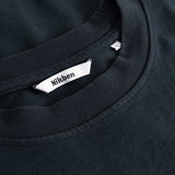 Closeup view of Nikben necklabel on black T-shirt